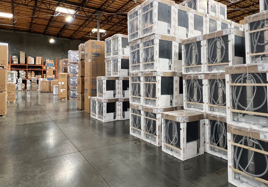 Overstock appliances in a warehouse, featuring packed kitchen appliances for liquidation and discounted sales.