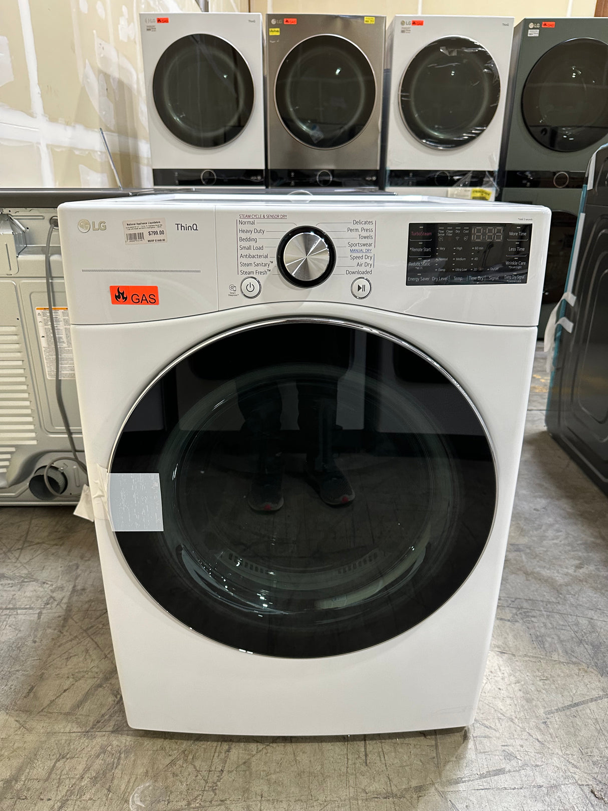 LG DLGX4201W LG - 7.4 Cu. Ft. Stackable Smart Gas Dryer with Steam and Built In Intelligence - White displayed in appliance showroom.