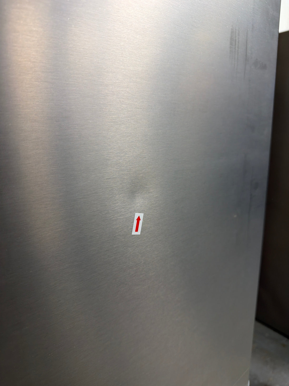 Frigidaire FRFC2323AS - 23 Cu. Ft. Counter-Depth French Door Refrigerator - Scratch & Dent showing minor dent on stainless steel surface.