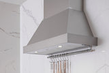 Bertazzoni KC36HERTAV BZ-36" CANOPY HOOD IVORY mounted in a modern kitchen with cooking utensils.