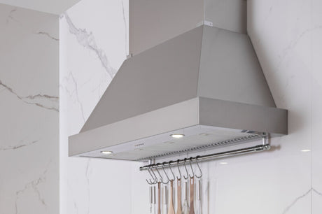 Bertazzoni KC36HERTAV BZ-36" CANOPY HOOD IVORY mounted in a modern kitchen with cooking utensils.
