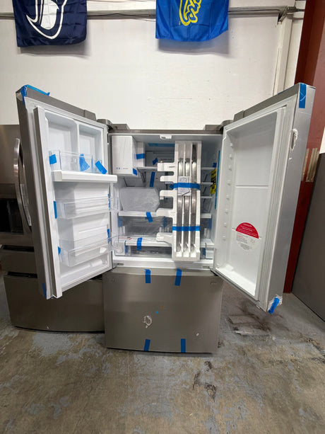 Frigidaire FRFC2323AS - 23 Cu. Ft. Counter-Depth French Door Refrigerator - Scratch & Dent open with storage compartments.
