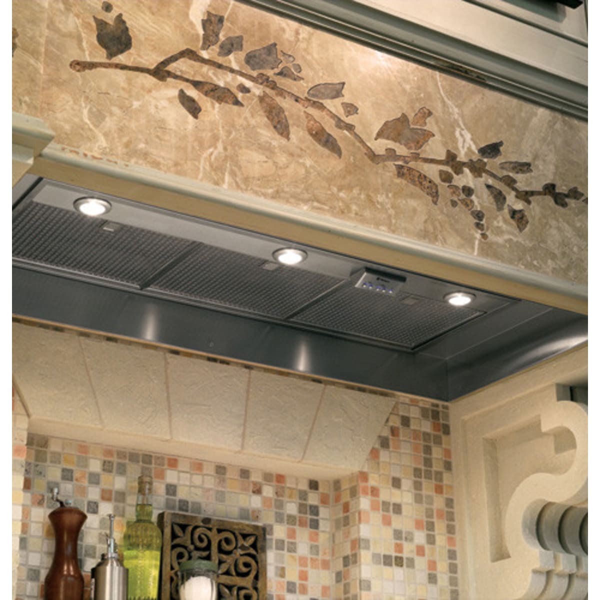 Monogram ZVC42LSS 42 Inch Custom Hood Insert with 1,200 CFM Internal Dual Blowers, 4-Speed Fan, 4-Level Halogen Lamps and ADA Compliant Remote-Mount Option installed in a stylish kitchen.