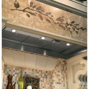 Monogram ZVC42LSS 42 Inch Custom Hood Insert with 1,200 CFM Internal Dual Blowers, 4-Speed Fan, 4-Level Halogen Lamps and ADA Compliant Remote-Mount Option installed in a stylish kitchen.